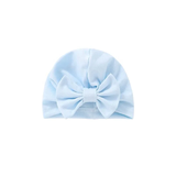 The Pret my baby cotton woven turban cap for babies comes in light blue with a large matching front bow, shown against a plain white background.