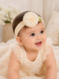 pretmybaby cream baby headband featuring a delicate layered flower and lace leaves worn by a smiling infant