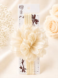 pretmybaby cream baby headband featuring a large layered fluffy flower, perfect for special occasions and photoshoots.