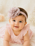 pretmybaby infant wearing a soft pastel pink layered fluffy flower headband, perfect for special occasions.