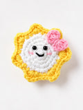 pretmybaby handmade crochet hairclip featuring a yellow and white smiling flower design with a small pink bow