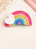 pretmybaby handmade crochet rainbow hairclip with a white heart accent on a soft beige background