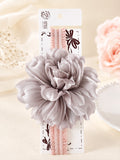 pretmybaby baby headband featuring a large layered dusty lavender fluffy flower on a soft pink ruffled elastic band