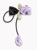 pretmybaby hairclip featuring a lavender organza tulip, sage green bow, and dangling bud on a black hair tie