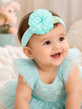 pretmybaby baby headband featuring a pastel mint flower and lace leaves worn by a smiling infant in a matching dress