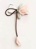 pretmybaby pastel organza tulip hairclip with a delicate dangling bud and white bow detail for special occasions