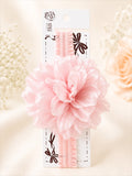 pretmybaby baby headband featuring a large layered pastel pink fluffy flower on a soft elastic band