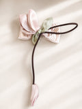 pretmybaby pastel organza tulip hairclip on a bow with a dangling bud, perfect for special occasions.