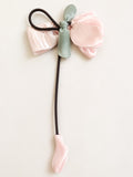 pretmybaby pastel organza tulip hairclip with a sage green bow and dangling pink bud on a light background