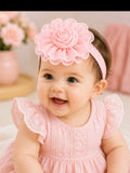 pretmybaby baby girl wearing a soft pink chiffon flower headband with a layered bud design for special occasions