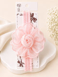 pretmybaby baby headband featuring a large layered pastel pink chiffon flower bud on a soft ruffled elastic band