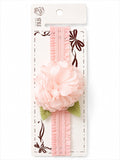 pretmybaby pastel pink baby headband featuring a layered fabric flower and delicate green lace leaves