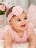 pretmybaby pastel pink baby headband with a layered flower and lace leaves worn by a smiling infant in a lace dress