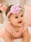pretmybaby infant headband featuring a soft pink layered flower and delicate lace leaves on a smiling baby girl