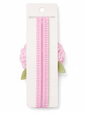 pretmybaby baby headband featuring a soft pink layered flower and delicate green lace leaves on a ruffled pink band