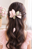pretmybaby pastel pink organza tulip hairclip with dangling bud worn in wavy hair for special occasions