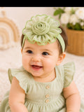 pretmybaby infant wearing a soft sage green chiffon flower headband with layered petals for a special occasion