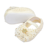 The Pret my baby Rosette bellies with star in cream feature white soles, gold star accents, a tulle bow, and a soft elastic strap—making them the perfect charming gift for any infant.