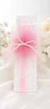 The Fancy fascinator pearls on tulle baby headband by Pret my baby features a white tag with pink tulle, pearl bow, and sheer ribbon—an elegant accent for baby or toddler headbands. Perfectly presented with white roses and baby's breath.