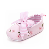 The Pret my baby Embroidery bellies with stripe bow - pink features a single pink shoe with floral embroidery, scalloped edge, large striped bow, and non-slip sole, displayed on a white background.