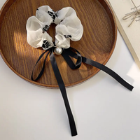 Retro black and white scrunchie with pearl and ribbon bow