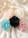 pretmybaby extra large layered organza flower hairclips in pastel and black colors on a soft satin fabric background