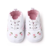 The Pret my baby Embroidery sneakers - white feature pink floral embroidery, white laces, and a soft pink lining—perfect pre-walker shoes for babies, shown side by side on a white background.