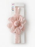 A soft pink baby headband featuring an extra large flower with a rose bud, displayed on a white card with the brand name Pret my baby at the top.