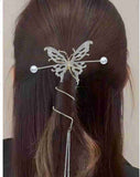 A person with long brown hair styled using the Pretmebabe Large Butterfly Buckle with Spiral, featuring pearl-like ends and a dangling chain accent.