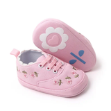 Pret my baby Embroidery sneakers - pink: Delicate pink floral pre-walker baby shoes with white scalloped edges, pink laces, and soles decorated with a white flower, heart, and blue accents.