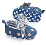 Pret my baby Embroidery bellies with stripe bow - blue: adorable baby shoes featuring floral embroidery, a bold black-and-white striped front bow, and non-slip soles with white paw print patterns for safety and charm.