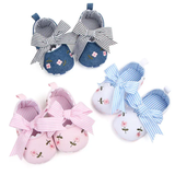Three pairs of Pret my baby embroidery bellies: white with blue stripes and embroidered bow, blue with white stripes and floral details, and pink with flower design. All have soft, non-slip soles and cute decorative accents.
