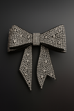 The Pretmebabe Midnight Sparkle Luxe Bow brooch, Style 3, shines with round diamonds set on a black bow and is displayed against a dark gradient background—an exquisite statement piece for elegant evenings.