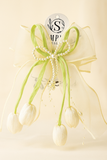 Introducing the Tulip with pearls large bow fascinator hairclip by Pret my baby—a sheer ivory bow with green accents, three satin tulip buds, and string of pearls attached to a circular tag—ideal for handcrafted hair accessory lovers.