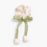 The pretmebabe Hanging Tulip scrunchie features off-white silk tulip shapes tied with a green ribbon—ideal for quirky hair accessories lovers seeking a cute, unique touch.